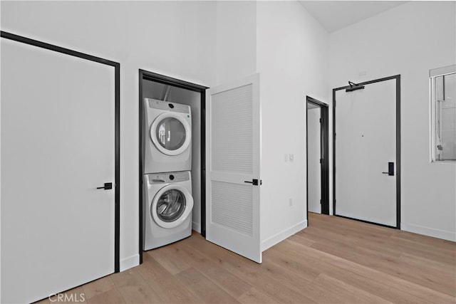 957 Figueroa Unit 318, Los Angeles, CA 90012 - laundry area featuring stacked washer / dryer and light wood-style flooring