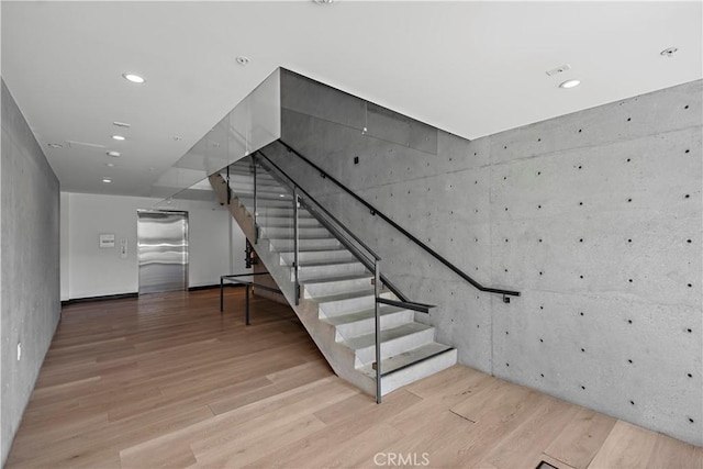 957 Figueroa Unit 318, Los Angeles, CA 90012 - stairs featuring wood finished floors, recessed lighting, and elevator