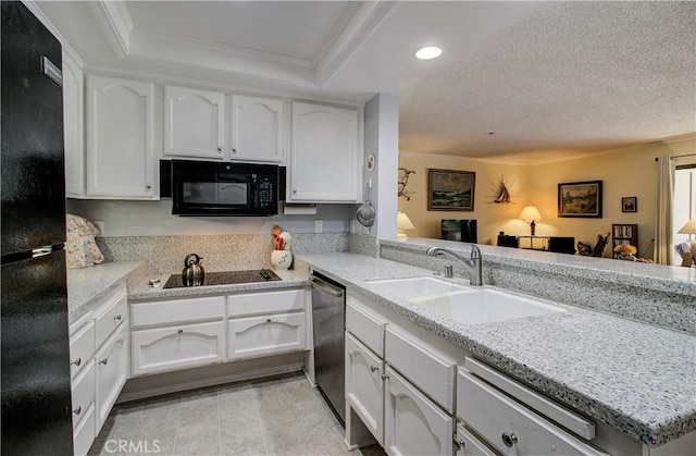 13601 Del Monte Dr Unit 51, Seal Beach, CA 90740 - kitchen with black appliances, white cabinets, light countertops, recessed lighting, and a peninsula