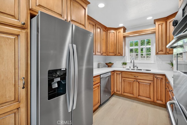 1303 E Monroe Ave, Orange, CA 92867 - kitchen featuring appliances with stainless steel finishes, recessed lighting, light wood-type flooring, brown cabinets, and light countertops