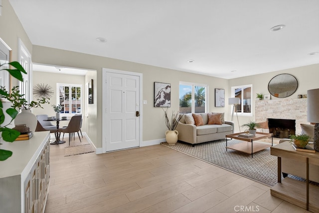 1303 E Monroe Ave, Orange, CA 92867 - living area featuring a stone fireplace and light wood-style floors