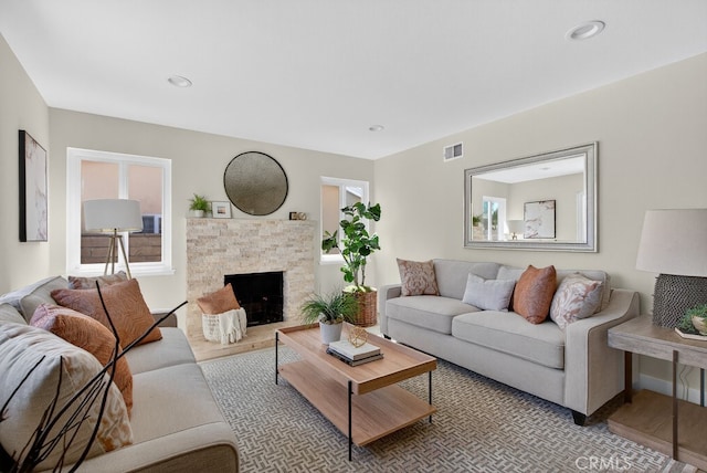 1303 E Monroe Ave, Orange, CA 92867 - living room with a stone fireplace and light wood-style flooring
