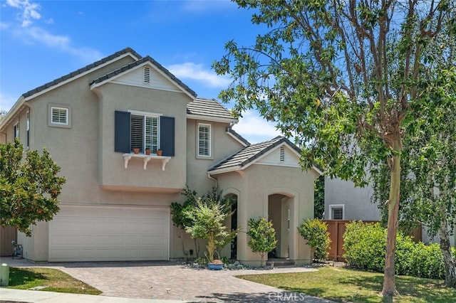 10 Cumberland Ln, Aliso Viejo, CA 92656 - traditional-style house with stucco siding, a tile roof, decorative driveway, and an attached garage