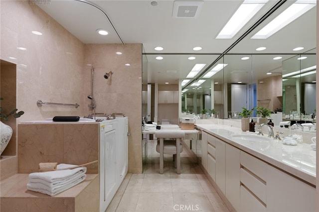 10490 Wilshire Blvd Unit 2704, Los Angeles, CA 90024 - bathroom with tile patterned floors, vanity, tile walls, a bathtub, and recessed lighting