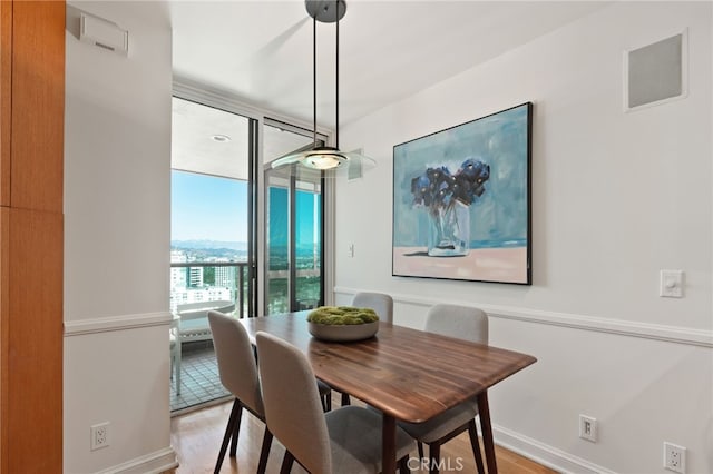 10490 Wilshire Blvd Unit 2704, Los Angeles, CA 90024 - dining space featuring light wood-style floors and floor to ceiling windows