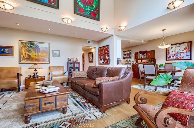 2015 E Broadway Unit 402, Long Beach, CA 90803 - living room with wood finished floors, a towering ceiling, and recessed lighting
