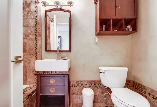 2015 E Broadway Unit 402, Long Beach, CA 90803 - bathroom featuring vanity, tile walls, tiled bath, and a shower