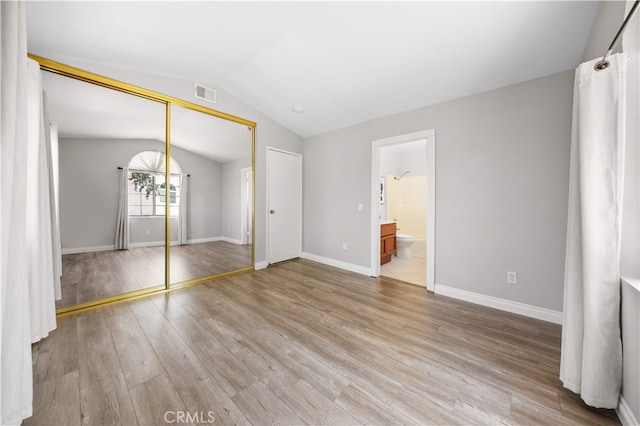 13199 Spire Cir, Chino Hills, CA 91709 - unfurnished bedroom with vaulted ceiling, light wood-style flooring, a closet, and connected bathroom