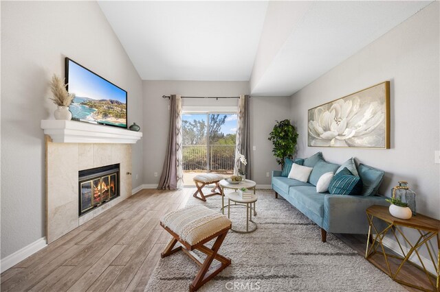 13199 Spire Cir, Chino Hills, CA 91709 - living room with lofted ceiling, wood finished floors, and a fireplace
