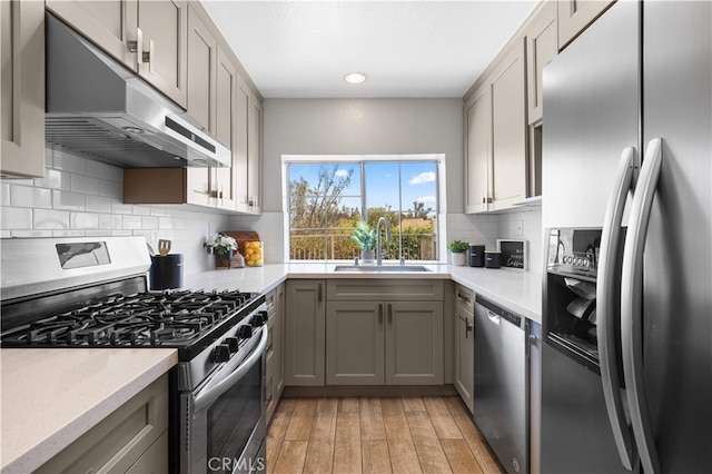 13199 Spire Cir, Chino Hills, CA 91709 - kitchen with appliances with stainless steel finishes, gray cabinetry, under cabinet range hood, decorative backsplash, and recessed lighting