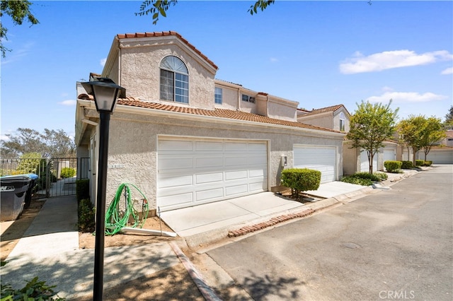 13199 Spire Cir, Chino Hills, CA 91709 - mediterranean / spanish home featuring a tiled roof, stucco siding, concrete driveway, and a garage