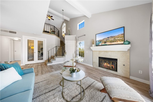 13199 Spire Cir, Chino Hills, CA 91709 - living area with beamed ceiling, stairway, wood finished floors, a fireplace, and ceiling fan