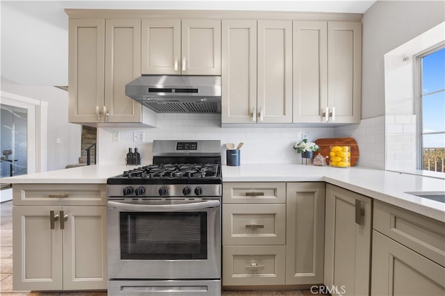 13199 Spire Cir, Chino Hills, CA 91709 - kitchen featuring gas range, wall chimney exhaust hood, light countertops, backsplash, and gray cabinetry