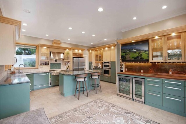 1525 Ramona Dr, Camarillo, CA 93010 - kitchen with beverage cooler, appliances with stainless steel finishes, wall chimney range hood, decorative backsplash, and recessed lighting