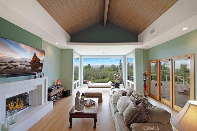 1525 Ramona Dr, Camarillo, CA 93010 - living area featuring wood finished floors, wooden ceiling, a warm lit fireplace, and recessed lighting
