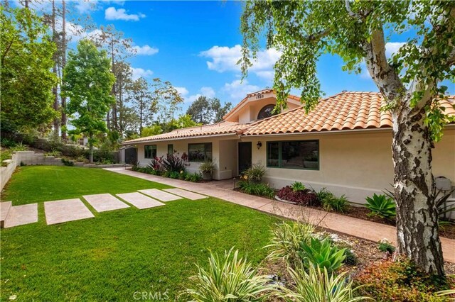 1525 Ramona Dr, Camarillo, CA 93010 - back of property featuring stucco siding, a lawn, and a tile roof