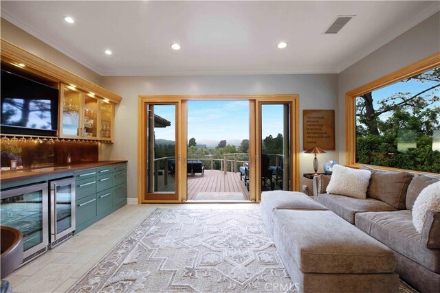 1525 Ramona Dr, Camarillo, CA 93010 - living room featuring a bar, wine cooler, crown molding, recessed lighting, and stone tile floors