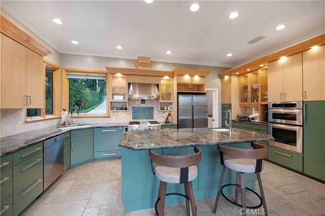1525 Ramona Dr, Camarillo, CA 93010 - kitchen featuring appliances with stainless steel finishes, exhaust hood, stone tile flooring, tasteful backsplash, and recessed lighting