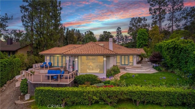1525 Ramona Dr, Camarillo, CA 93010 - rear view of property featuring a chimney, a tiled roof, a wooden deck, stucco siding, and a patio