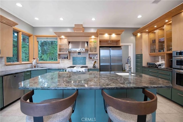 1525 Ramona Dr, Camarillo, CA 93010 - kitchen with stainless steel appliances, wall chimney exhaust hood, decorative backsplash, a kitchen bar, and recessed lighting