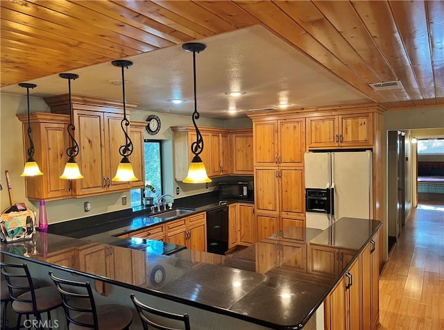 44293 Copper Creek Way, Coarsegold, CA 93614 - kitchen with black appliances, dark countertops, a peninsula, light wood finished floors, and wooden ceiling
