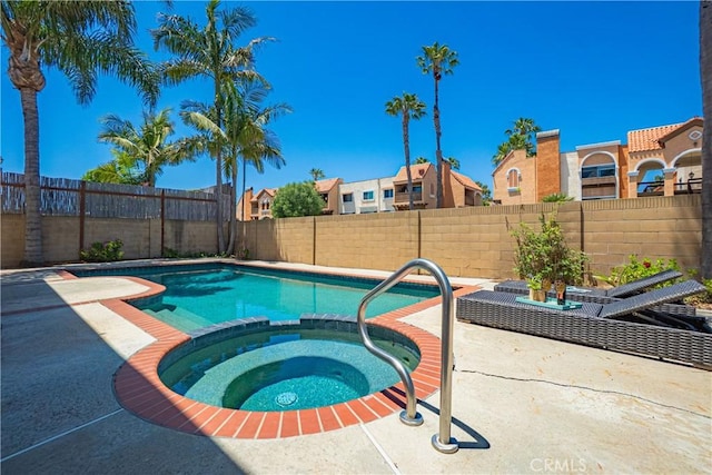 9921 Oceancrest Dr, Huntington Beach, CA 92646 - view of swimming pool featuring a patio area, a fenced backyard, and a pool with connected hot tub