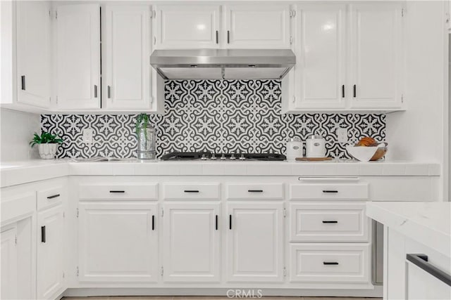 9921 Oceancrest Dr, Huntington Beach, CA 92646 - kitchen with gas stovetop, ventilation hood, and white cabinets