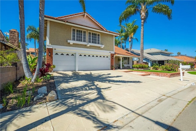 9921 Oceancrest Dr, Huntington Beach, CA 92646 - traditional-style house with an attached garage, driveway, stucco siding, and a tiled roof
