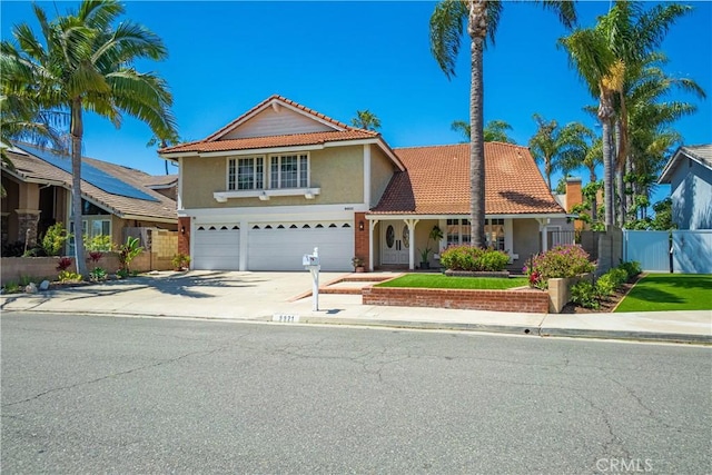 9921 Oceancrest Dr, Huntington Beach, CA 92646 - traditional-style house featuring an attached garage, a tile roof, driveway, and stucco siding
