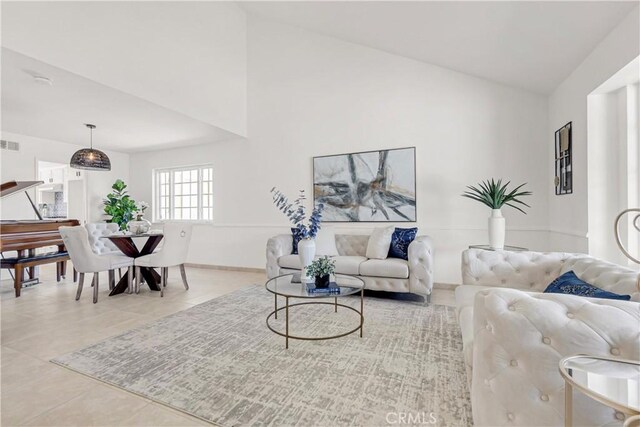 9921 Oceancrest Dr, Huntington Beach, CA 92646 - tiled living area featuring high vaulted ceiling and baseboards