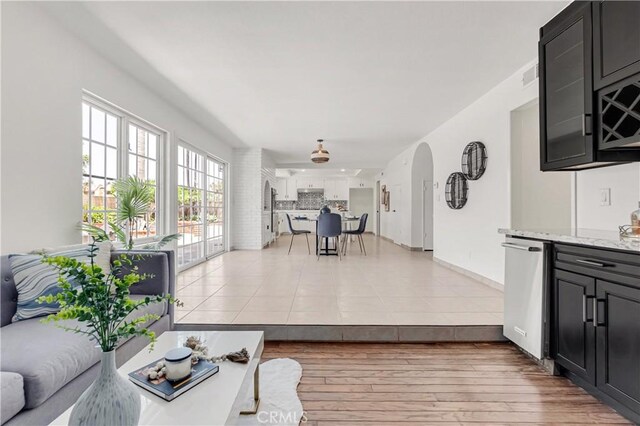 9921 Oceancrest Dr, Huntington Beach, CA 92646 - living room with light wood finished floors and arched walkways