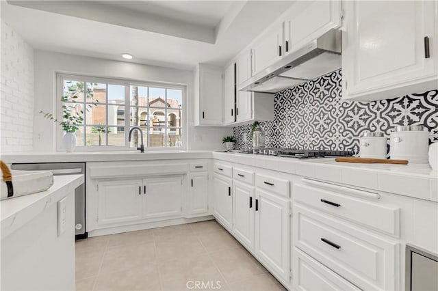 9921 Oceancrest Dr, Huntington Beach, CA 92646 - kitchen featuring stainless steel gas cooktop, under cabinet range hood, light countertops, white cabinets, and recessed lighting