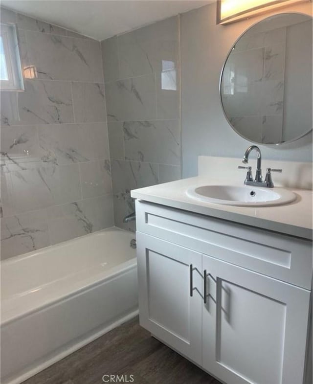 1220 W 7th St, San Bernardino, CA 92411 - full bathroom featuring vanity, wood finished floors, and tub / shower combination