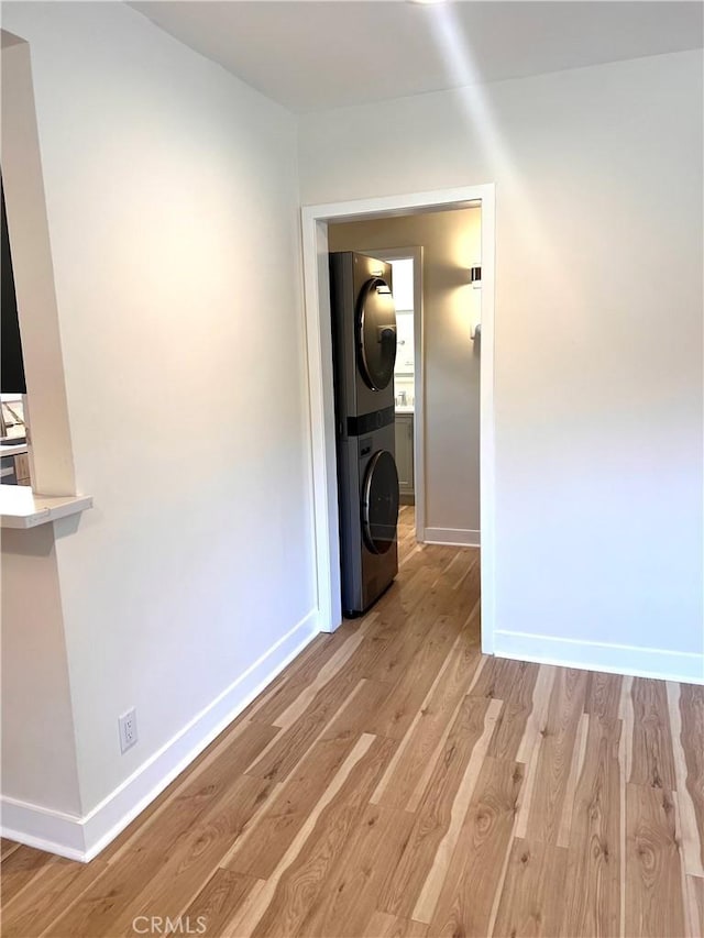 5126 Colfax Ave, Valley Village, CA 91601 - laundry room with stacked washer and clothes dryer and light wood-style flooring