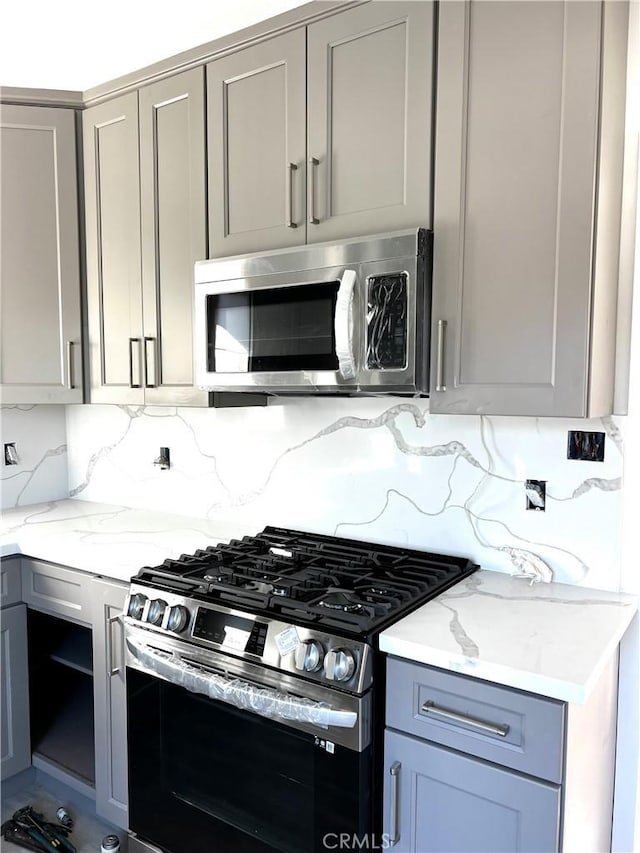 5126 Colfax Ave, Valley Village, CA 91601 - kitchen featuring stainless steel appliances, gray cabinets, and backsplash