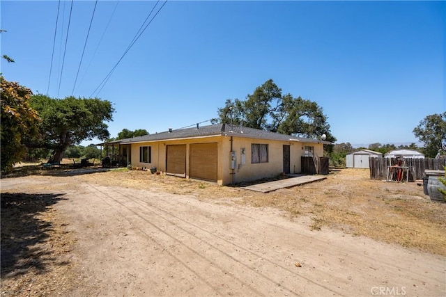 422 Zenon Way, Arroyo Grande, CA 93420 - view of front facade with a shed, a garage, and stucco siding
