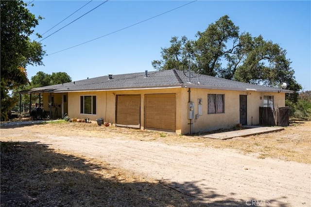 422 Zenon Way, Arroyo Grande, CA 93420 - back of house featuring a garage, stucco siding, and dirt driveway