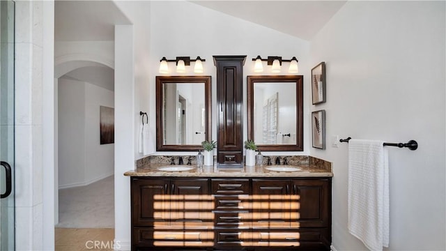 16 Bayleaf Ln, Irvine, CA 92620 - bathroom featuring double vanity, vaulted ceiling, and an enclosed shower