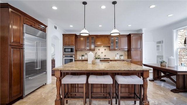 16 Bayleaf Ln, Irvine, CA 92620 - kitchen with built in appliances, custom range hood, tasteful backsplash, a kitchen breakfast bar, and glass insert cabinets