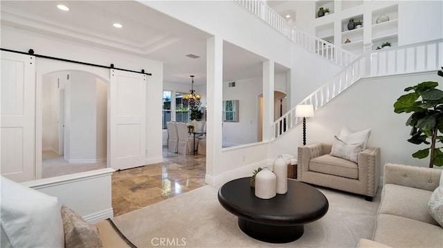 16 Bayleaf Ln, Irvine, CA 92620 - living area featuring a barn door, stairway, recessed lighting, and arched walkways