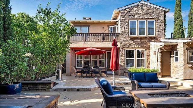 16 Bayleaf Ln, Irvine, CA 92620 - rear view of property with a balcony, stone siding, a patio area, and stucco siding