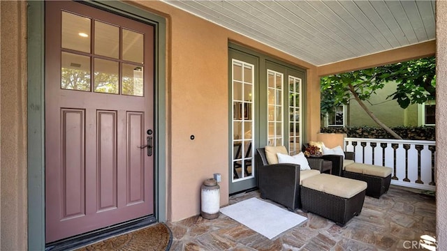 16 Bayleaf Ln, Irvine, CA 92620 - entrance to property featuring covered porch, stucco siding, and french doors