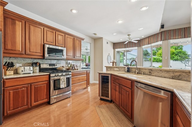 11272 Weatherby Rd, Los Alamitos, CA 90720 - kitchen with stainless steel appliances, beverage cooler, recessed lighting, light wood finished floors, and backsplash