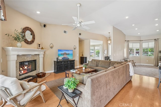 11272 Weatherby Rd, Los Alamitos, CA 90720 - living area with light wood finished floors, recessed lighting, ceiling fan, a fireplace, and lofted ceiling