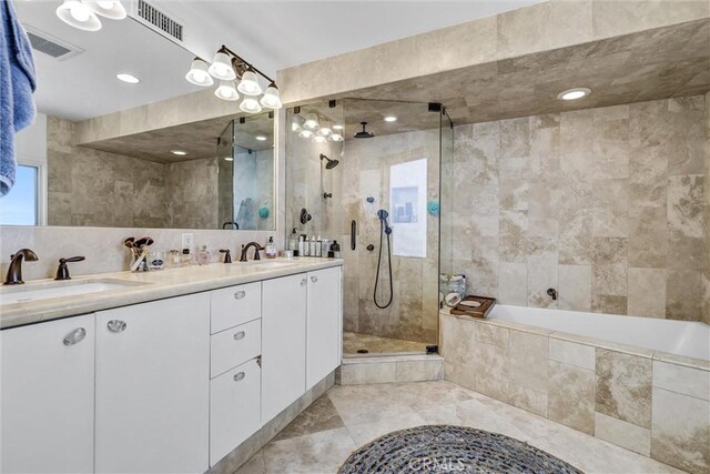 34586 Camino Capistrano Unit A, Dana Point, CA 92624 - full bathroom with tiled shower, double vanity, a bath, plenty of natural light, and tile walls