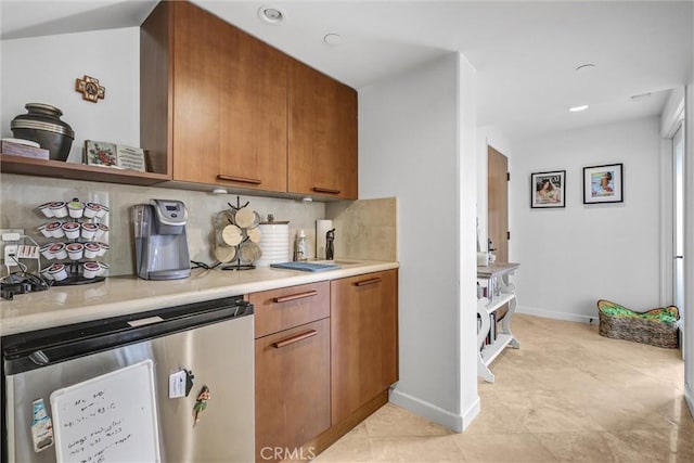 34586 Camino Capistrano Unit A, Dana Point, CA 92624 - kitchen with backsplash, brown cabinetry, light countertops, light tile patterned floors, and recessed lighting