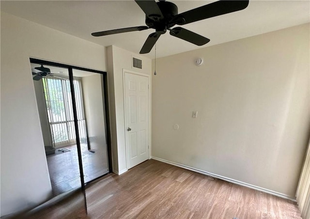 8601 International Ave Unit 271, Canoga Park, CA 91304 - unfurnished bedroom with wood finished floors, a closet, and ceiling fan