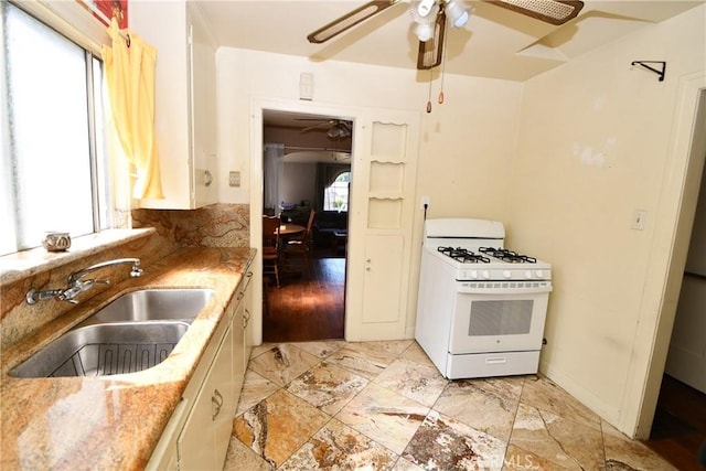 1862 261st St, Lomita, CA 90717 - kitchen featuring white gas range oven, ceiling fan, and plenty of natural light