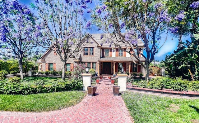 14207 Ashton Ln, Riverside, CA 92508 - view of front of home with brick siding, a front yard, and covered porch