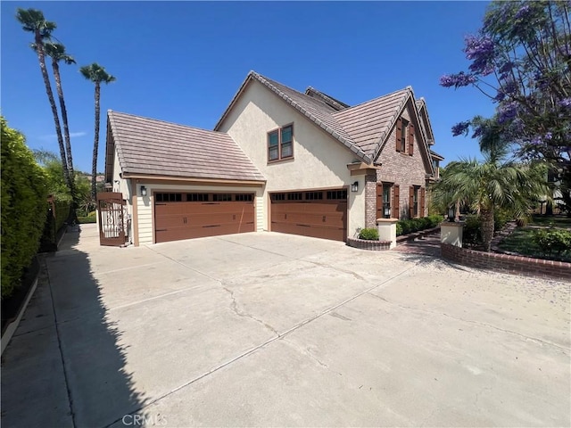14207 Ashton Ln, Riverside, CA 92508 - view of front of property with concrete driveway, stucco siding, a garage, and a tile roof